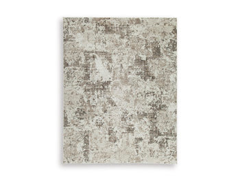 Ashley Furniture Barricland Rug with intricate patterns in warm tones, showcasing a plush, woven texture perfect for living spaces.