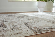Close-up of Ashley Furniture Barricland Rug with intricate patterns and textured fabric in neutral tones.