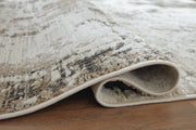 Close-up of Ashley Furniture Barricland Rug showing detailed woven pattern and textured surface in neutral tones.