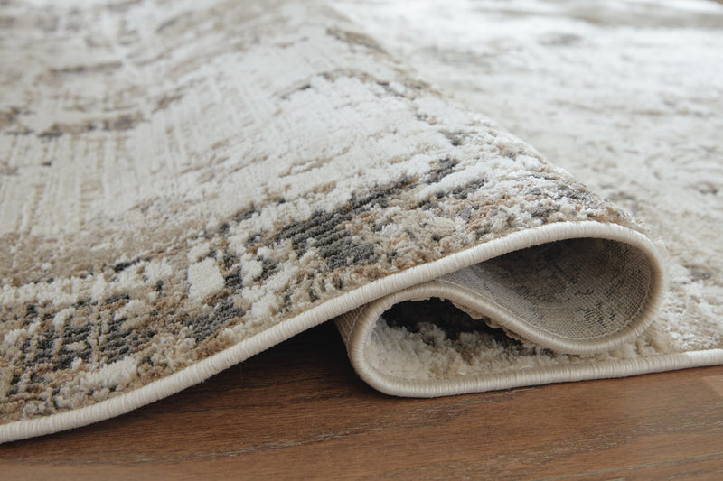Close-up of Ashley Furniture Barricland Rug showing detailed woven pattern and textured surface in neutral tones.