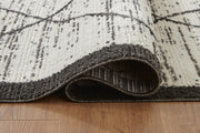 Close-up of the detailed pattern on the Fenriston Rug by Ashley Furniture, showcasing its textured, woven design.
