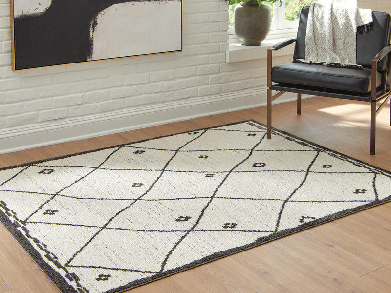 Ashley Furniture Fenriston Rug in neutral tones, close-up showing woven texture and intricate pattern on a soft, durable rug.