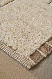 Close-up of Ashley Furniture Clayman Rug showcasing its textured, woven design in earthy tones for a cozy, stylish home decor.