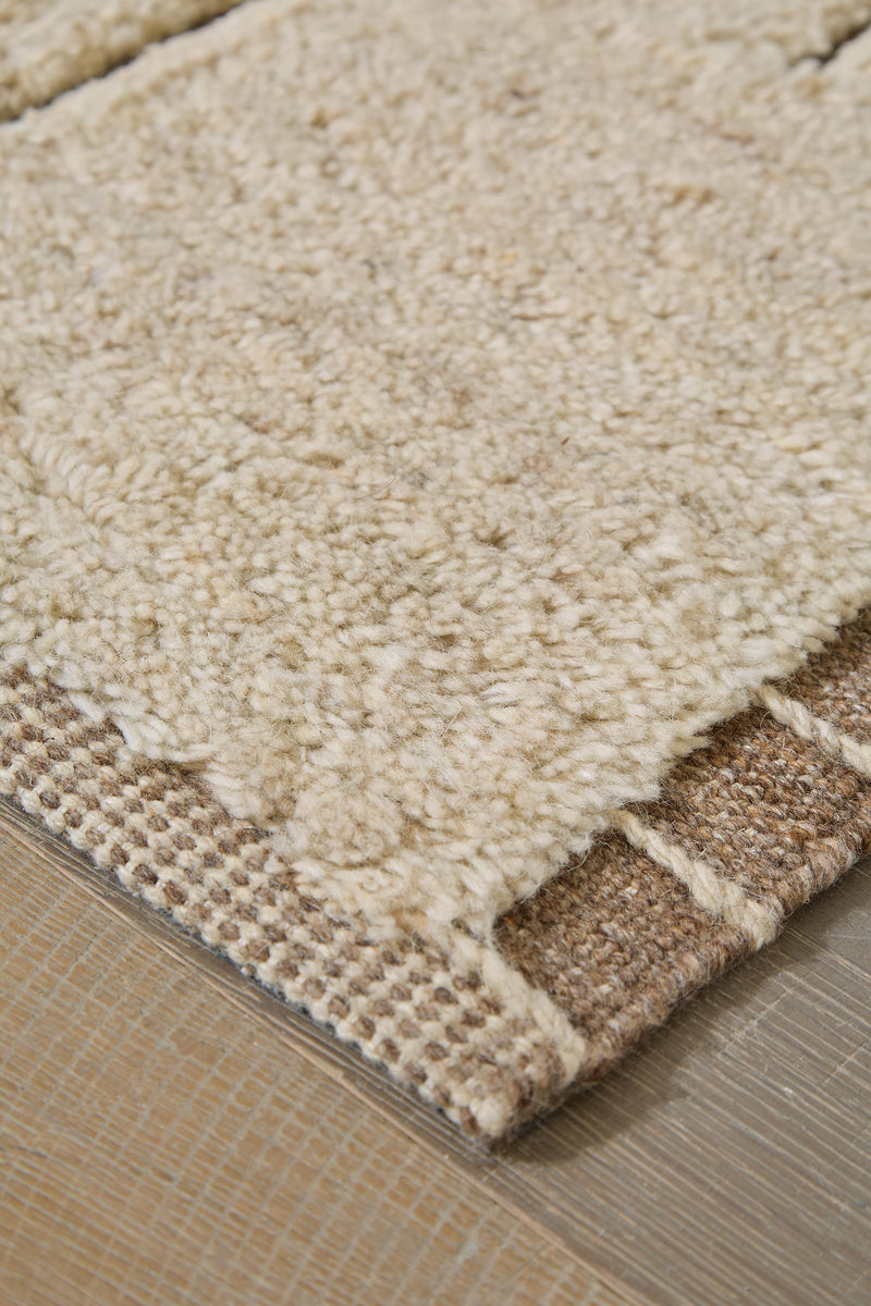 Close-up of Ashley Furniture Clayman Rug showcasing its textured, woven design in earthy tones for a cozy, stylish home decor.