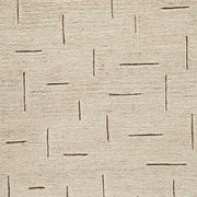Ashley Furniture Clayman Rug swatch showing textured woven pattern in neutral earthy tones.