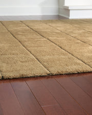 Close-up of the Luzmont Rug by Ashley Furniture featuring a detailed, textured design in neutral tones.