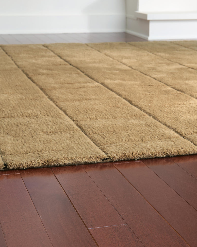 Close-up of the Luzmont Rug by Ashley Furniture featuring a detailed, textured design in neutral tones.