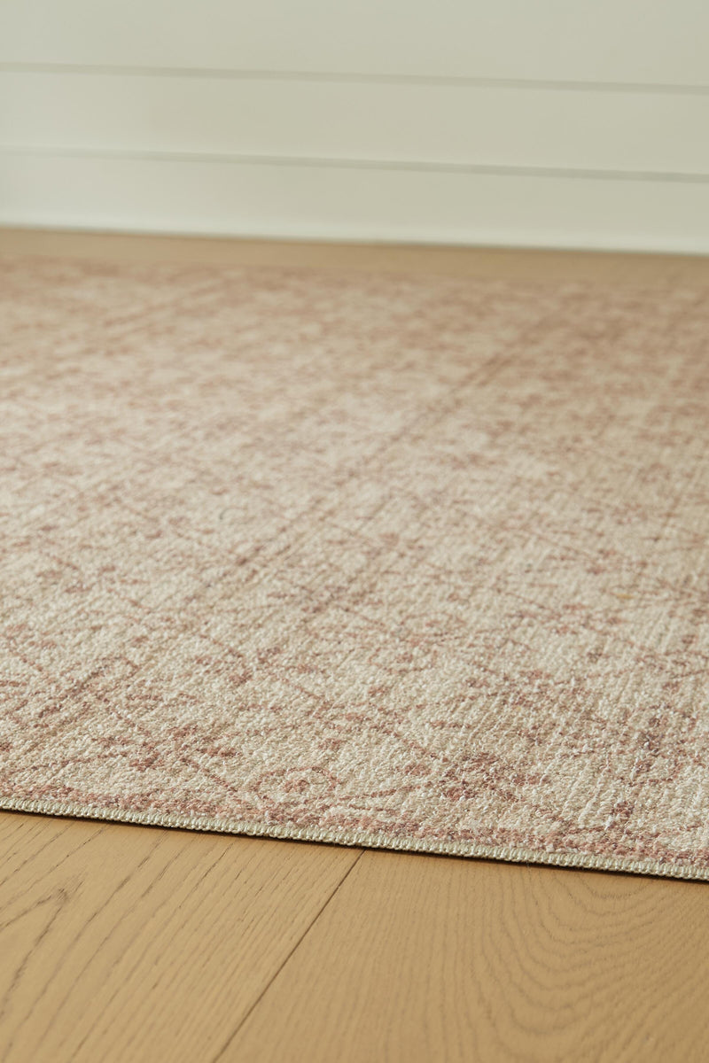 Close-up of the Ashley Furniture Lyamford Rug showcasing intricate woven patterns and rich textures in neutral tones.