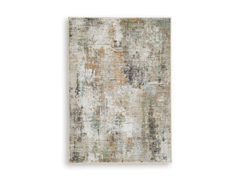 Ashley Furniture Torinette Rug with intricate patterns in neutral tones, showcasing a soft, plush texture for cozy living spaces.