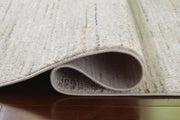 Close-up of the Ashley Furniture Harjot Rug showing intricate woven pattern and soft texture in neutral tones.