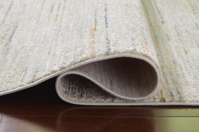 Close-up of the Ashley Furniture Harjot Rug showing intricate woven pattern and soft texture in neutral tones.
