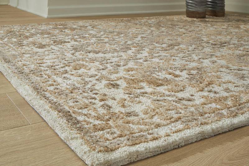 Close-up of Ashley Furniture Sableridge Medium Rug featuring intricate patterns and soft textures on a neutral background.