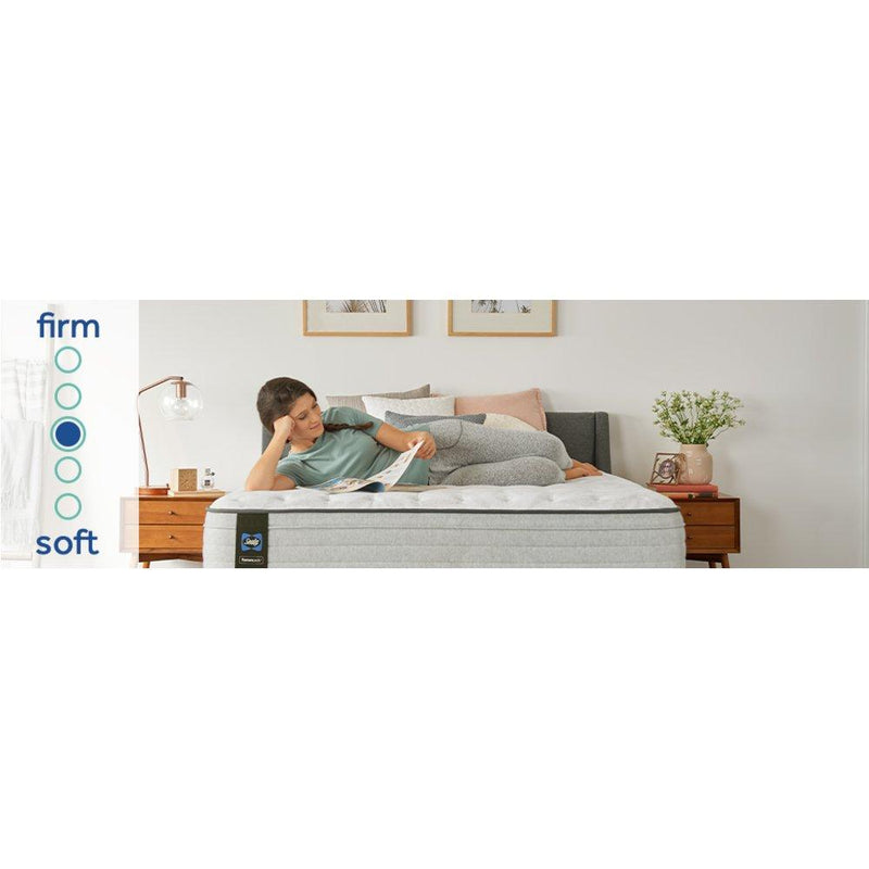 Sealy Garner II innerspring mattress with quilted top and supportive coils, shown in a well-lit bedroom setting.