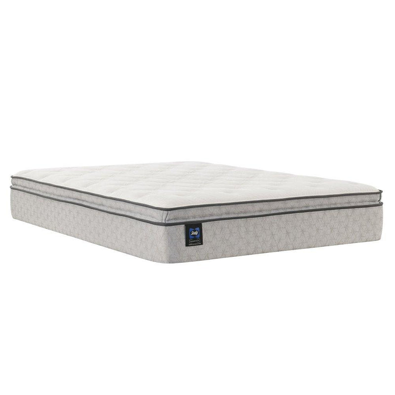 Sealy innerspring mattress with a plush top and supportive coils, shown in a neatly made bed setting.