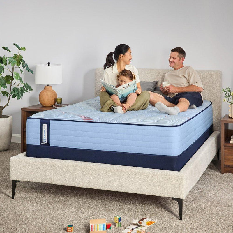 Sealy Fayette Spring Mattress with plush fabric cover and supportive foam layers, shown in a cozy bedroom setting.