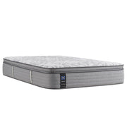 Sealy Lavina II innerspring mattress with a quilted top and supportive layers, shown in a bedroom setting.