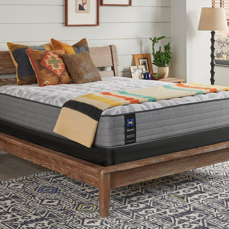 Sealy Philben innerspring mattress with plush fabric cover, showing a side view of the supportive and comfortable mattress design.