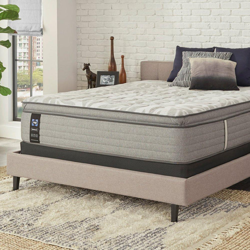 Sealy Lavina II innerspring mattress with plush quilted top, shown with clean, neutral bedding in a well-lit bedroom setting.