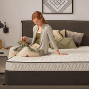 Sealy Spruce Innerspring Mattress showing a neatly made bed with white bedding and the mattress top visible.