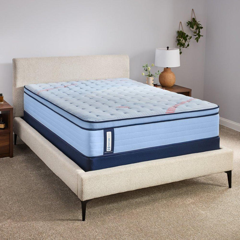 Sealy Fayette Spring Mattress showing a plush, supportive mattress with a quilted top and Sealy branding in a bedroom setting.