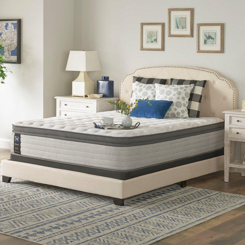 Sealy Garner II innerspring mattress with plush top, showing a close-up of the mattress surface and fabric detailing.