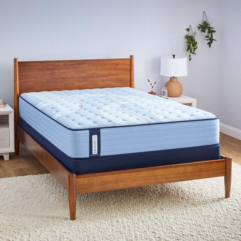 Sealy Kennett Spring Mattress with plush fabric cover, showing a neatly made bed with pillows in a cozy bedroom setting