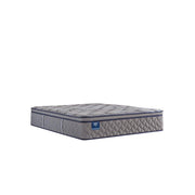 Sealy Sixth & Park innerspring mattress with plush fabric cover and supportive interior, shown on a bed frame in a bedroom setting.