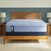 Sealy Dudley Hybrid Mattress showing a plush, layered surface with a white and gray fabric cover in a bedroom setting.