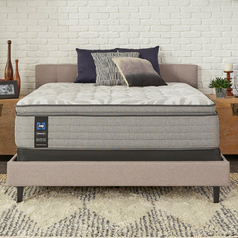 Sealy Lavina II innerspring mattress with plush top and supportive coils, showcasing a neatly made bed with white bedding.