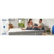 Sealy Leahy innerspring mattress with quilted top and supportive coils, shown in a well-lit bedroom setting.