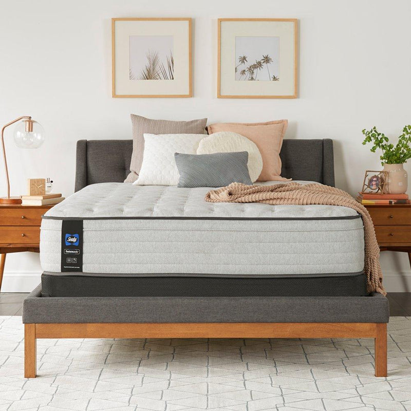 Sealy Garner II innerspring mattress with quilted top and supportive coils, shown in a well-made, plush bedroom setting.