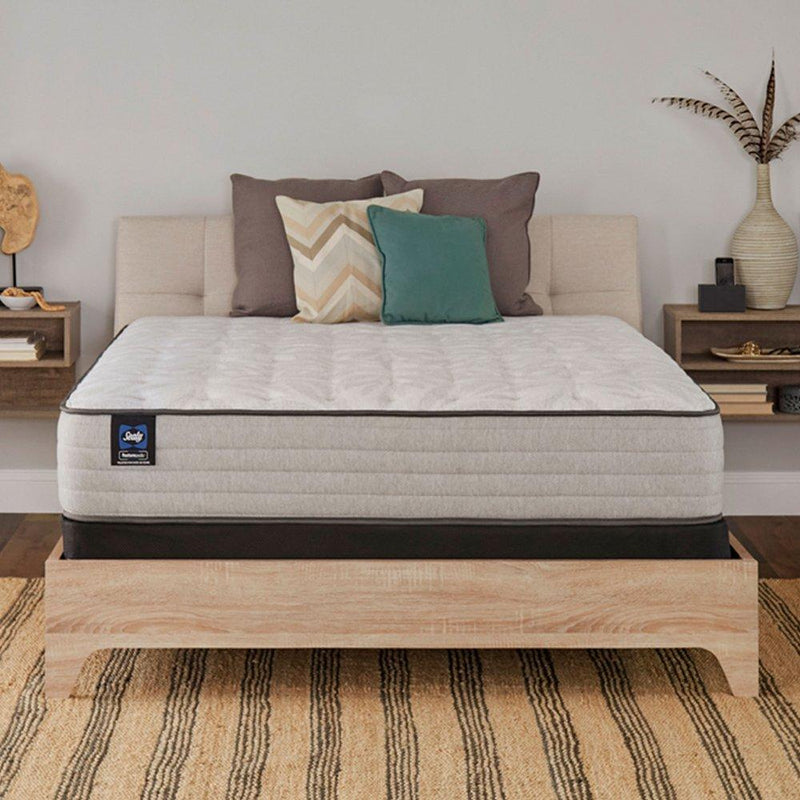 Sealy Spring Bloom innerspring mattress with plush top, showcasing a clean, comfortable bedding surface in a cozy bedroom setting.