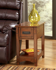 Ashley Furniture Breegin chairside end table showing a wooden surface with a drawer and lower shelf for storage.