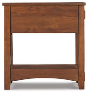 Ashley Furniture Breegin chairside end table with a wood finish, featuring a compact design and a single storage drawer.