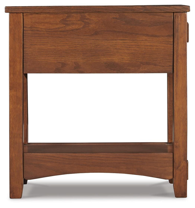 Ashley Furniture Breegin chairside end table with a wood finish, featuring a compact design and a single storage drawer.