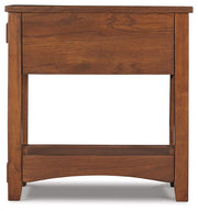 Ashley Furniture Breegin chairside end table with a dark wood finish and modern design, shown from a side view.
