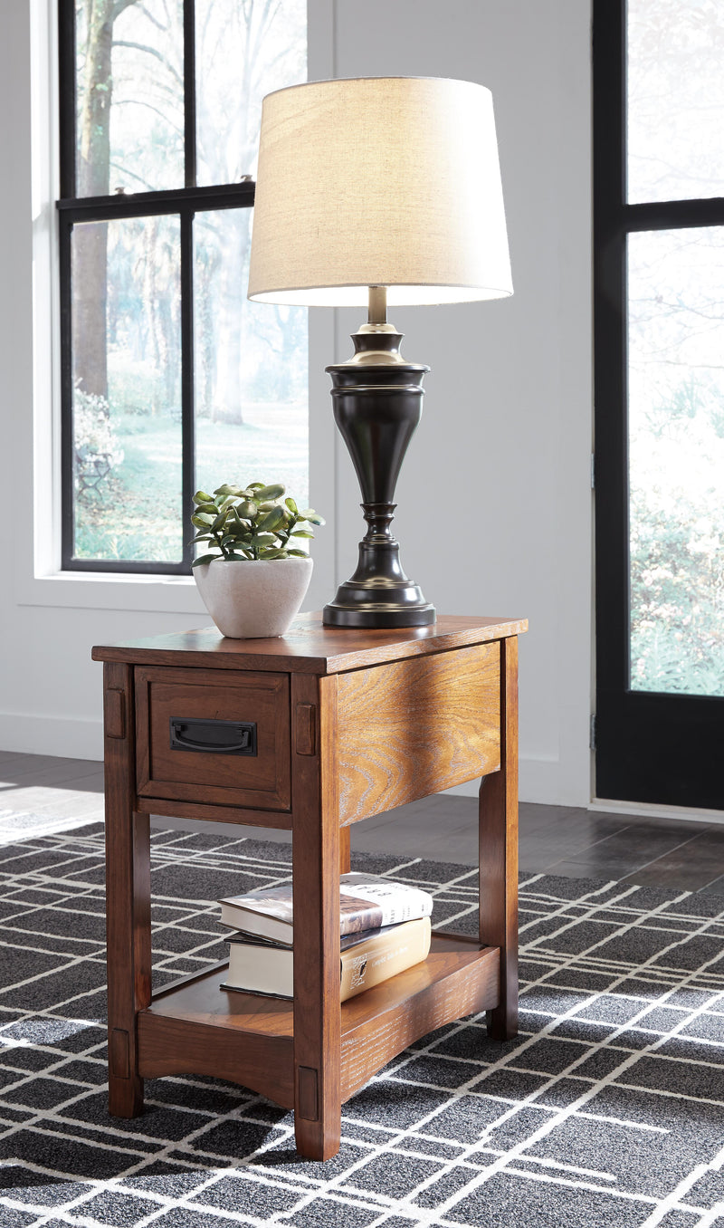 Ashley Furniture Breegin chairside end table with a wood finish, featuring a compact design suitable for living room seating areas.