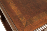 Ashley Furniture Breegin chairside end table with a dark wood finish, featuring a compact design and smooth tabletop surface.