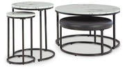 Set of four Ashley Furniture Jusmour nesting tables with sleek wooden tops and metal legs, arranged together in a modern living space.