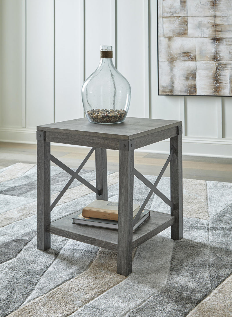 Ashley Furniture Freedan occasional table set featuring two modern, round tables with sleek wooden tops and metal legs.