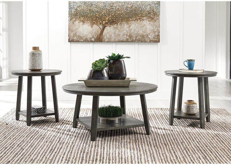 Set of three Ashley Furniture Caitbrook tables with wooden tops and tapered legs, arranged together in a modern living room setting.