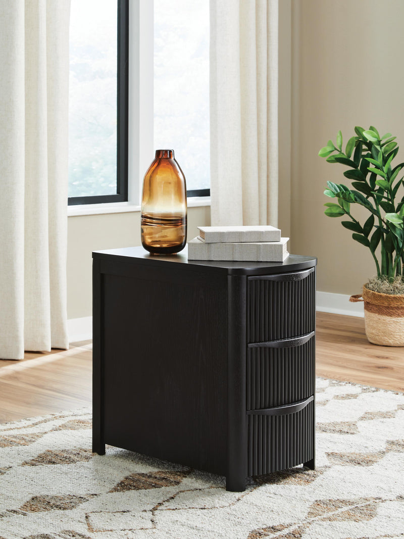 Ashley Furniture Camdill chairside end table with wood finish, featuring a compact design and storage shelf.