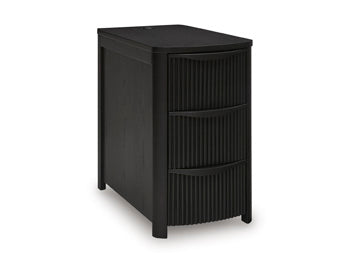 Ashley Furniture Camdill chairside end table with a dark wood finish, featuring a compact design and a single open shelf.