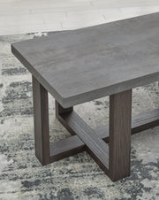 Set of three Ashley Furniture Dynnford tables with wood finish and sleek design, shown in a close-up detail shot.