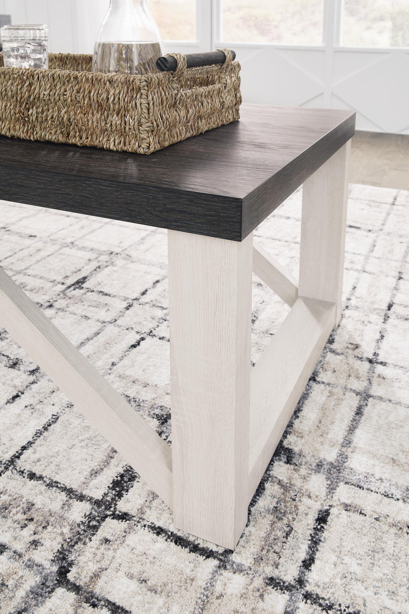 Set of three Ashley Furniture Dorrinson tables with wooden tops and metal legs, arranged together in a modern living space.
