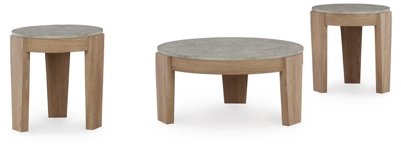 Set of three Ashley Furniture Guystone tables with angled design, featuring modern, sleek surfaces in a contemporary living space.