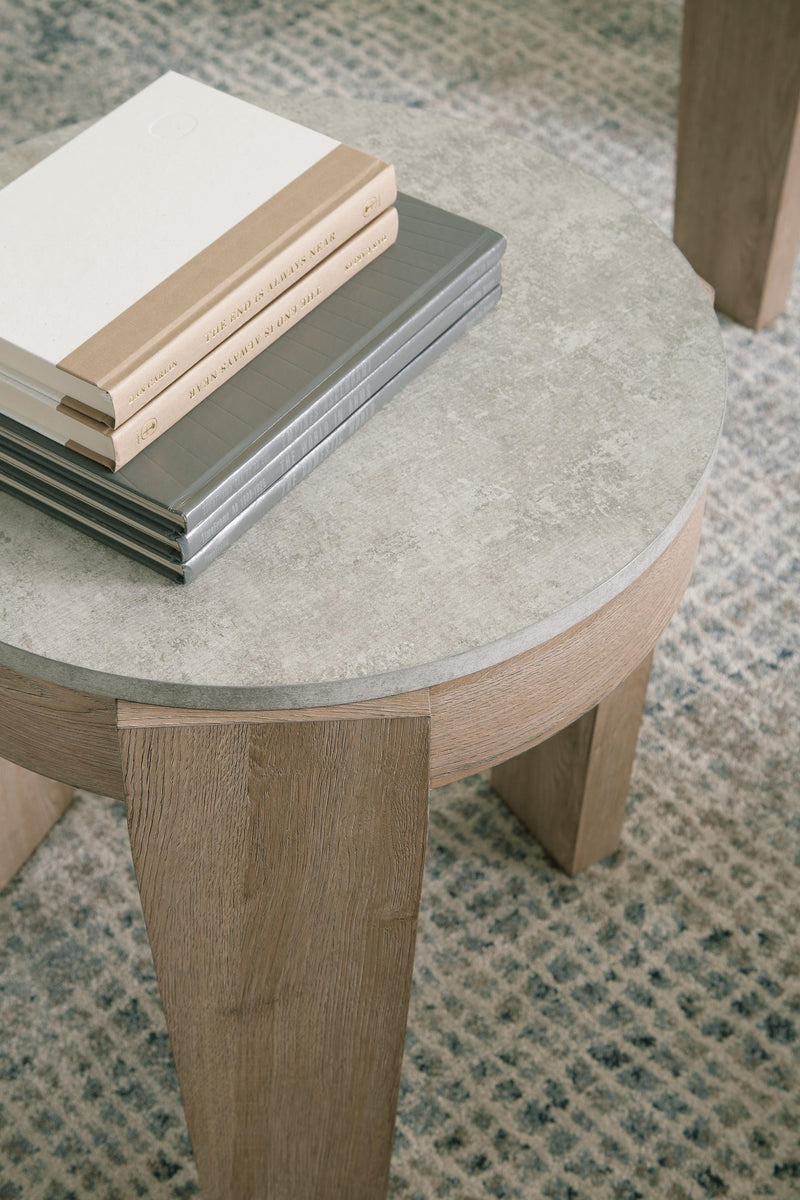 Set of three Ashley Furniture Guystone tables with modern design and textured stone finishes, perfect for living room decor.