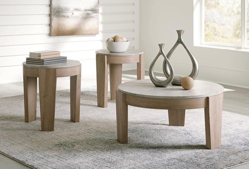 Set of three Ashley Furniture Guystone tables featuring modern design with textured stone surfaces and sleek black metal legs.