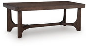 Ashley Furniture Korestone living room occasional table set with three modern tables featuring wood and metal finishes.