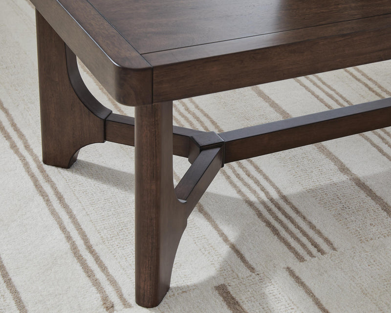 Ashley Furniture Korestone living room occasional table set with two sleek, modern tables featuring wood and metal finishes.